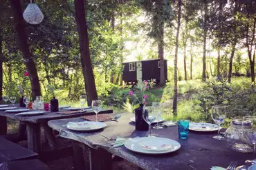 Dining alfresco on our rustic tables and benches.