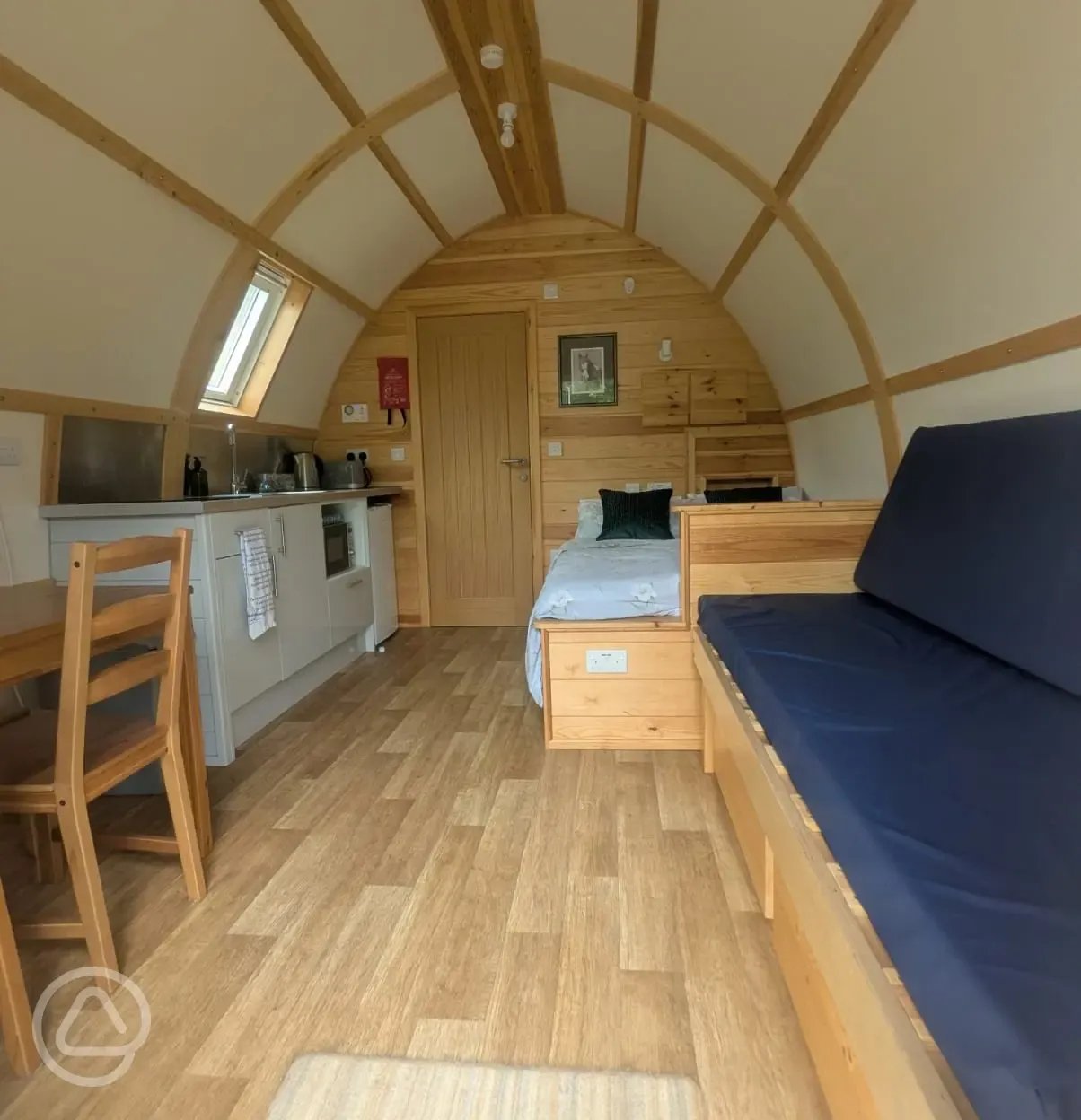Inside the glamping pods with kitchenette, lounge, double bed and dining area Inside the glamping pods with kitchenette, lounge, double bed and dining area