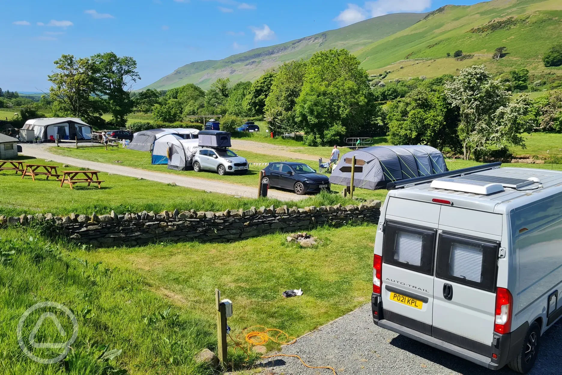 Electric hardstanding pitches set beside the stream Electric hardstanding pitches set beside the stream