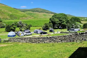 Large tents on grass pitches at Baystone Bank Farm overlooking Cumbrian fells
