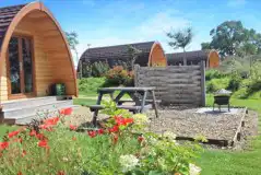 Ensuite glamping pod exterior with a picnic bench and fire pit Ensuite glamping pod exterior with a picnic bench and fire pit