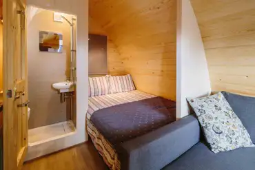 Ensuite glamping pod interior with a double bed at Notgrove Holidays