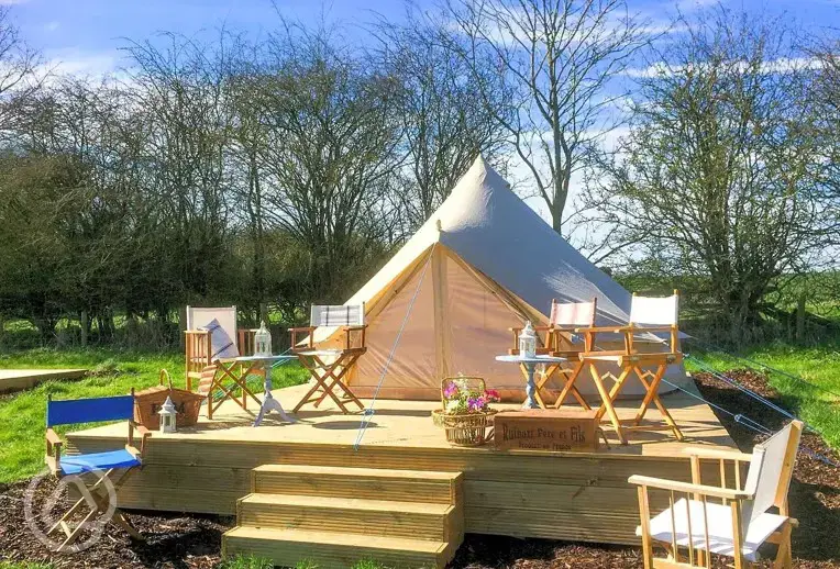Bell tents on a small wooden deck area