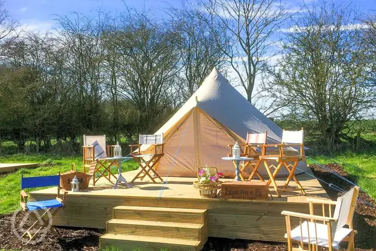Bell tents on a small wooden deck area