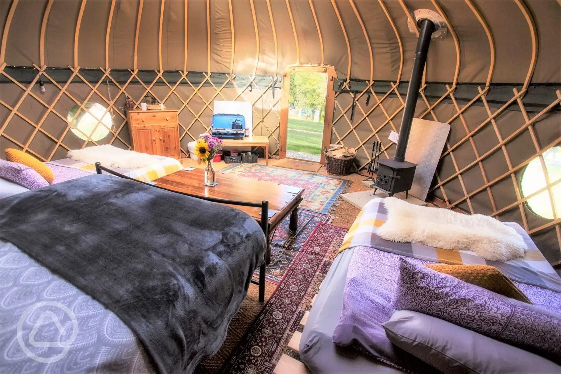 Interior view of Daisy Yurt, set up for a family