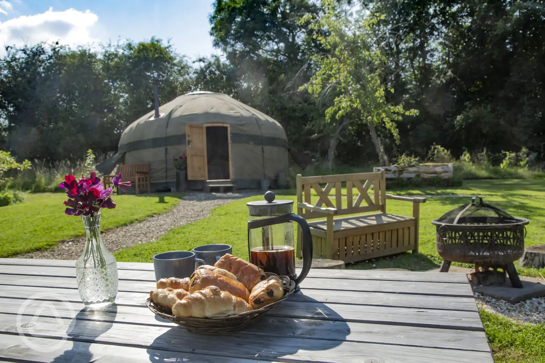 Alfresco breakfast of croissants and coffee outside the yurt