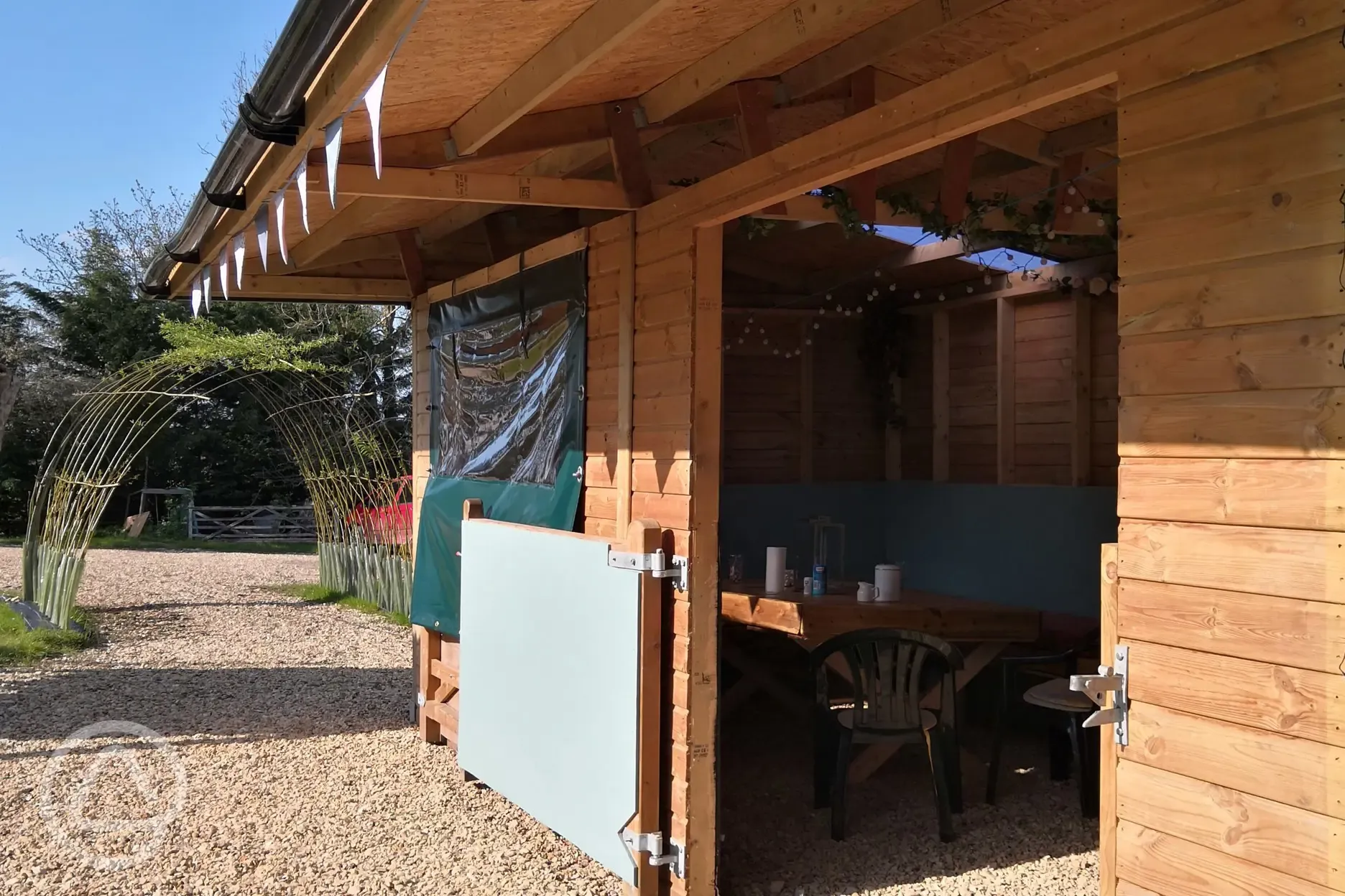 Campden Yurts' timber shelter for guests to eat or play games in