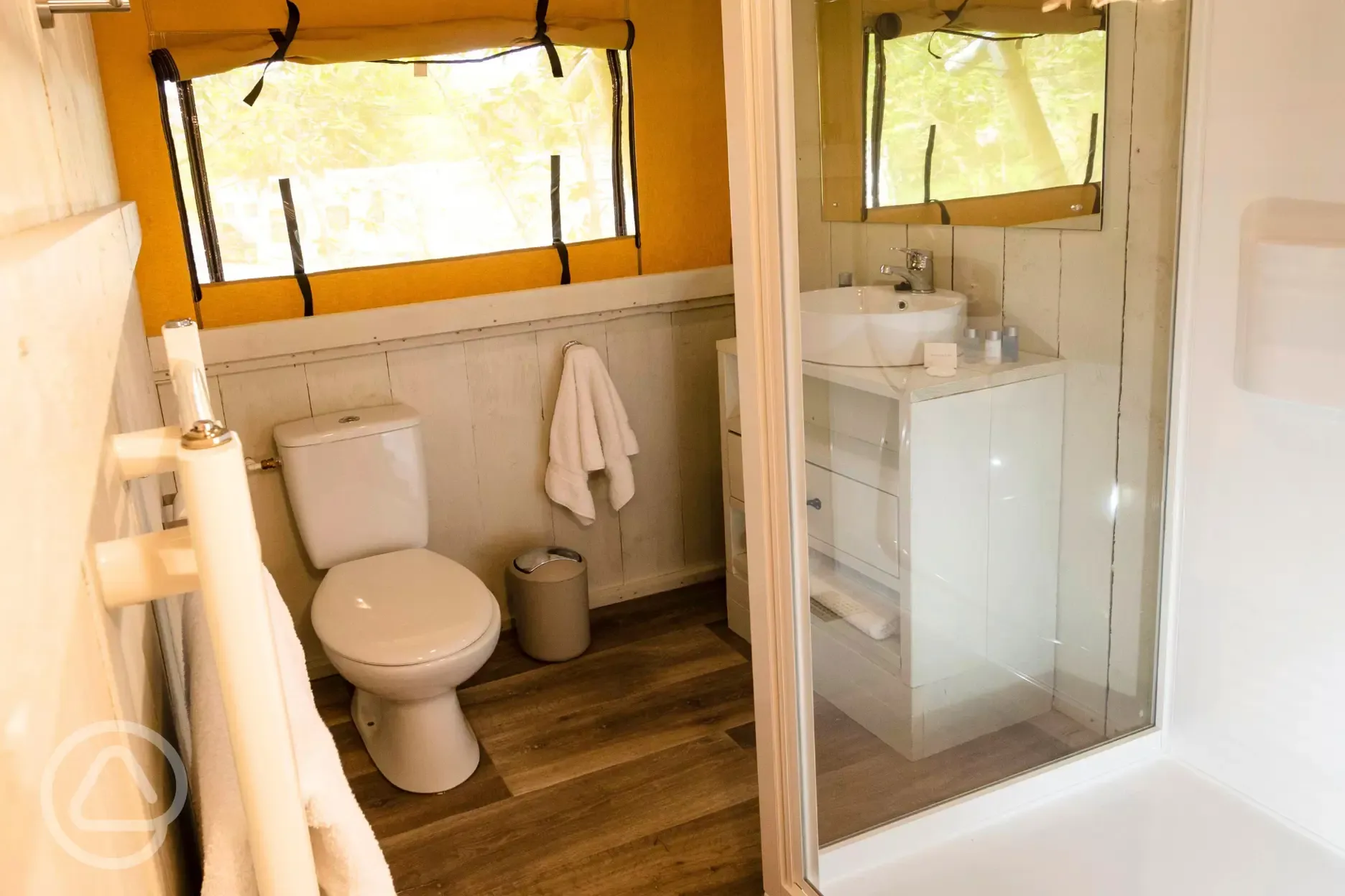 Safari tent ensuite bathroom with shower, toilets, sink and heated towel rail