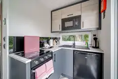 Hideaway pod kitchenette with an oven, fridge, hob, kettle and microwave