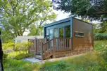 Hideaway ensuite glamping pod with a small deck area and surrounding trees