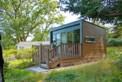 Hideaway ensuite glamping pod with a small deck area and surrounding trees