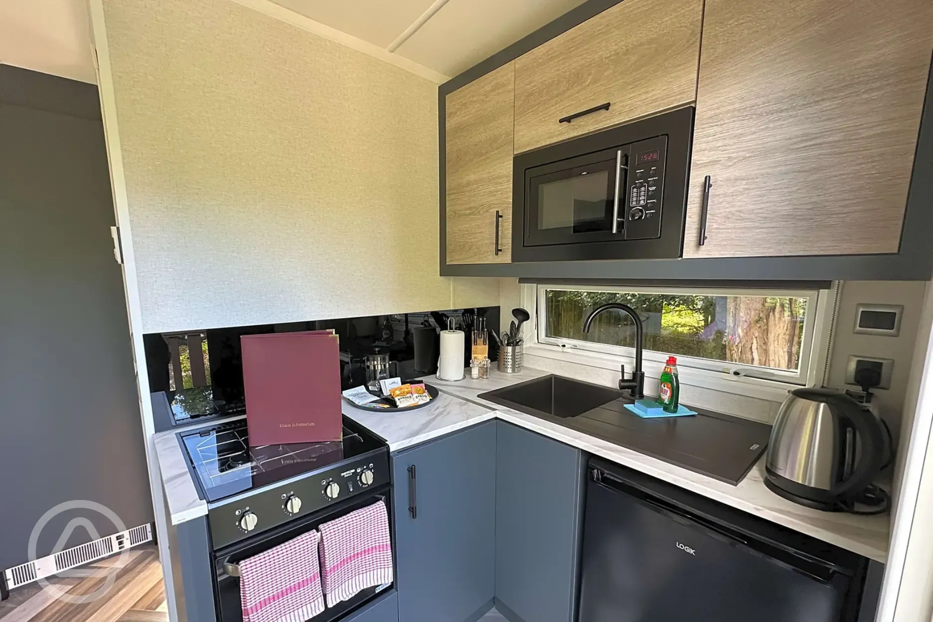 Hideaway pod kitchen with hob, grill, microwave, fridge, toaster and kettle