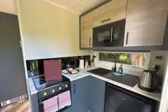 Hideaway pod kitchen with hob, grill, microwave, fridge, toaster and kettle