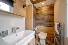 Family hideaway ensuite bathroom with toilet, shower, sink and heated towel rail