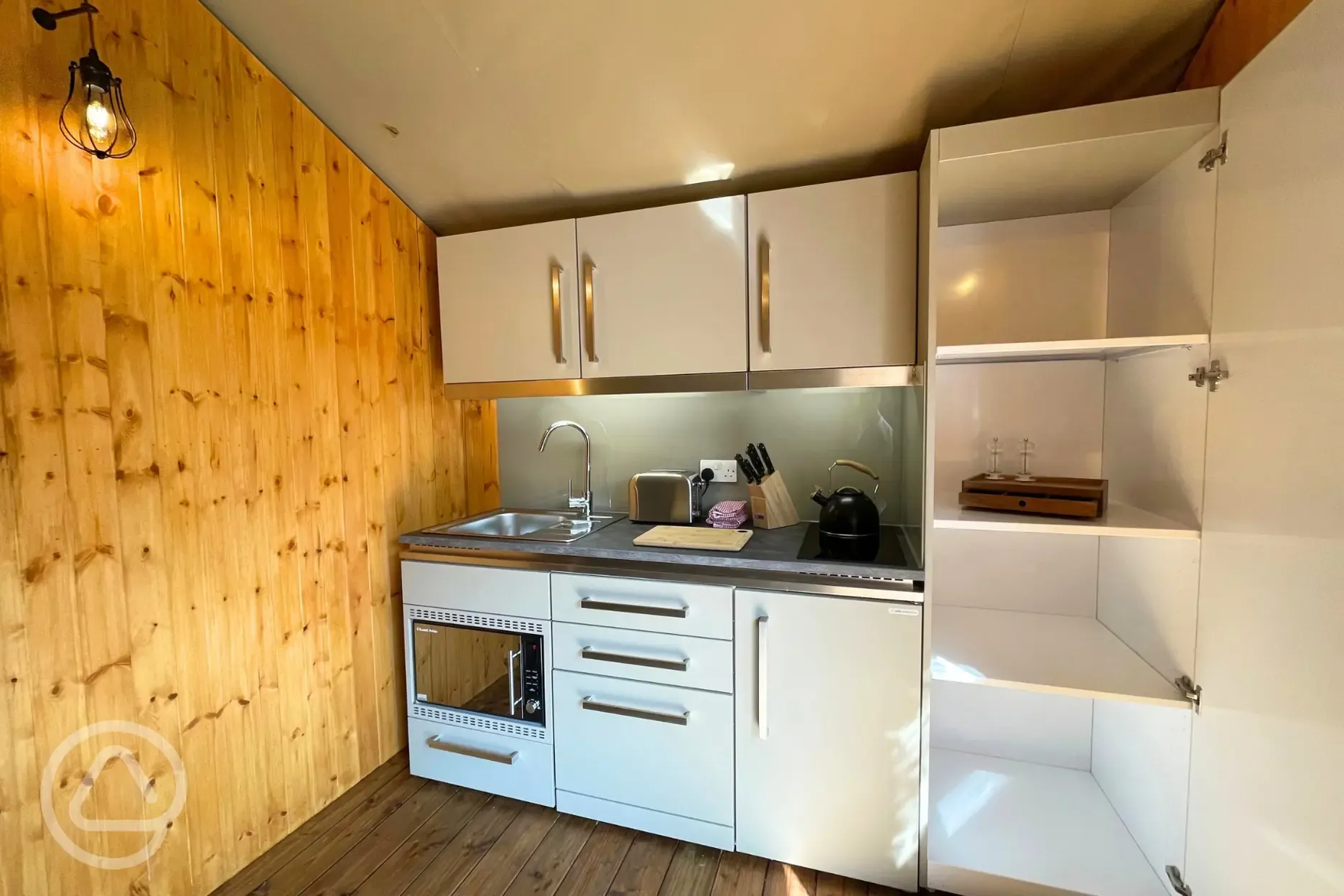 Luxury tent kitchen with a dishwasher, microwave/oven, fridge, toaster, kettle