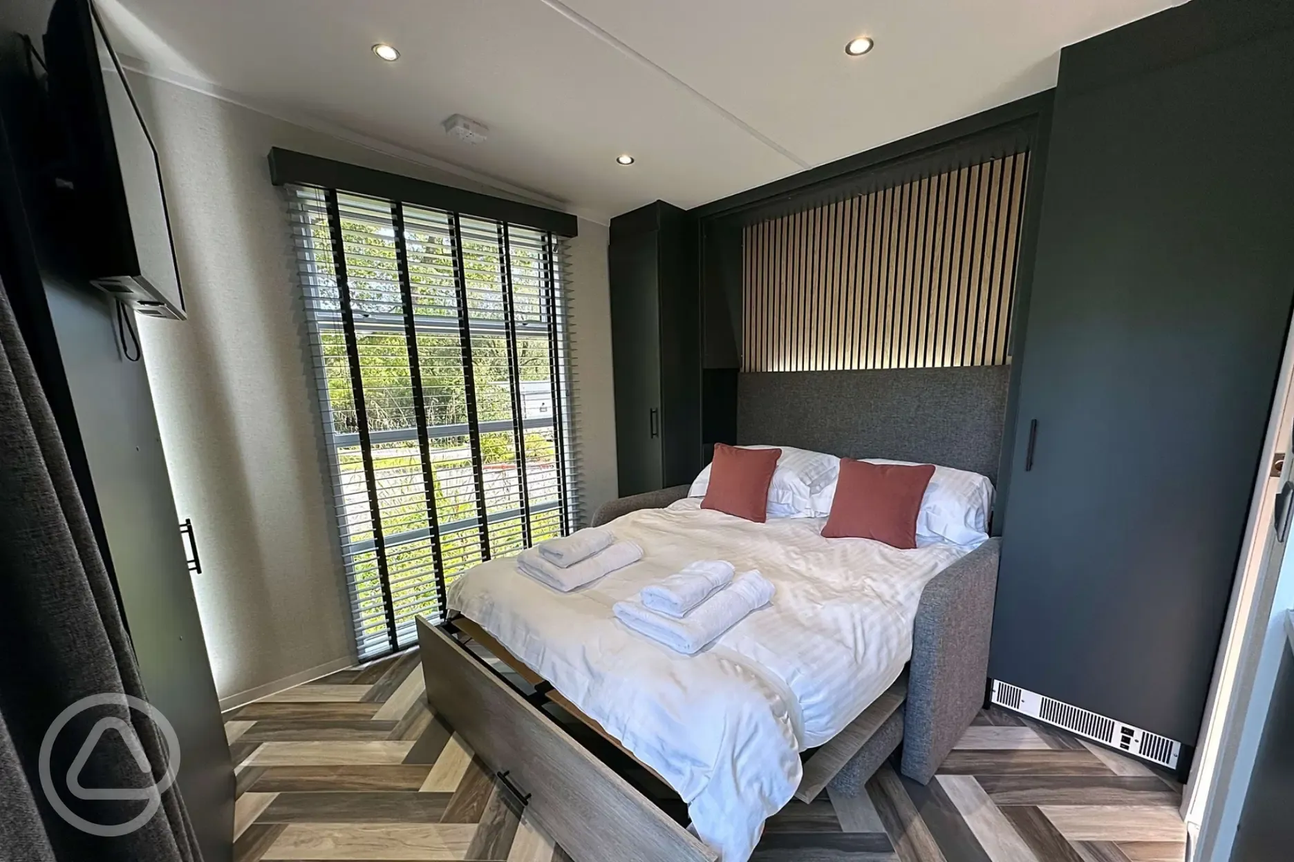 Hideaway pod interior with a double sofa bed and bedding