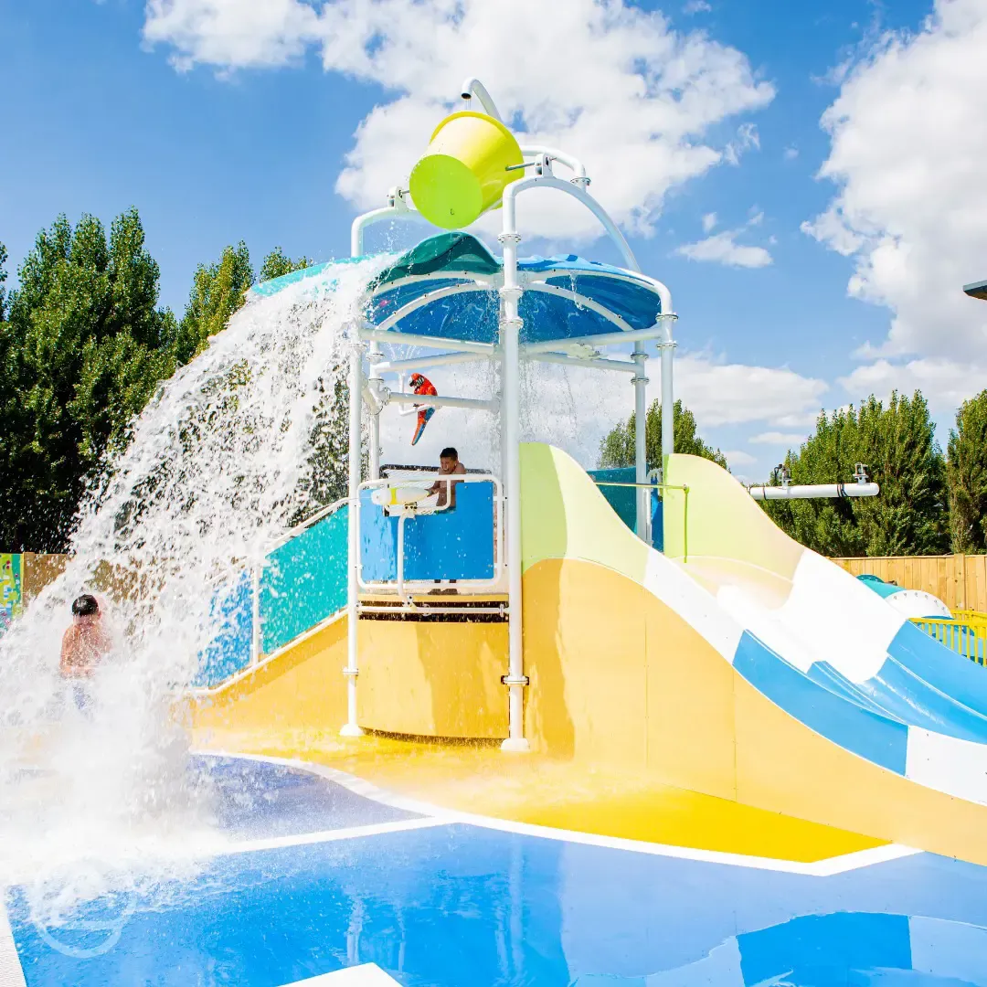 Outdoor swimming pool and water park with slides and water jets