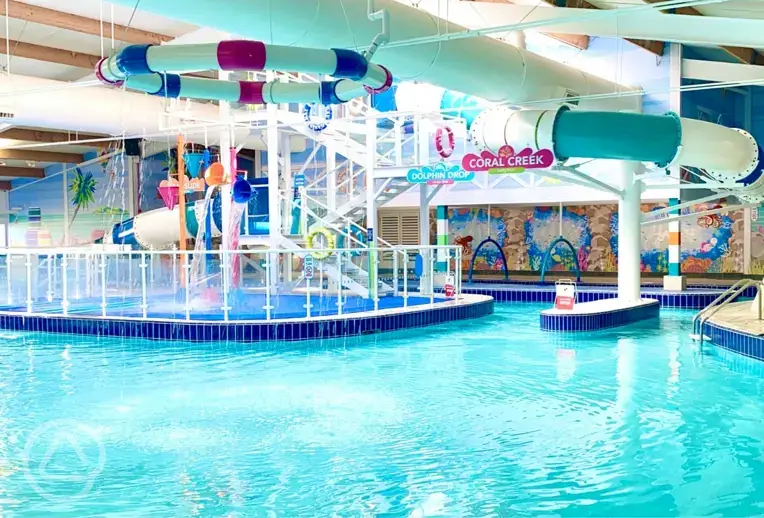 Indoor swimming pool with slides and a lazy river