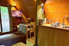 Pod dining area, TV and kitchenette Pod dining area, TV and kitchenette