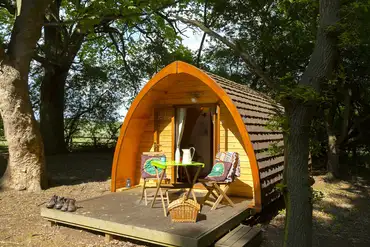 Glamping pod with a deck and outdoor furniture