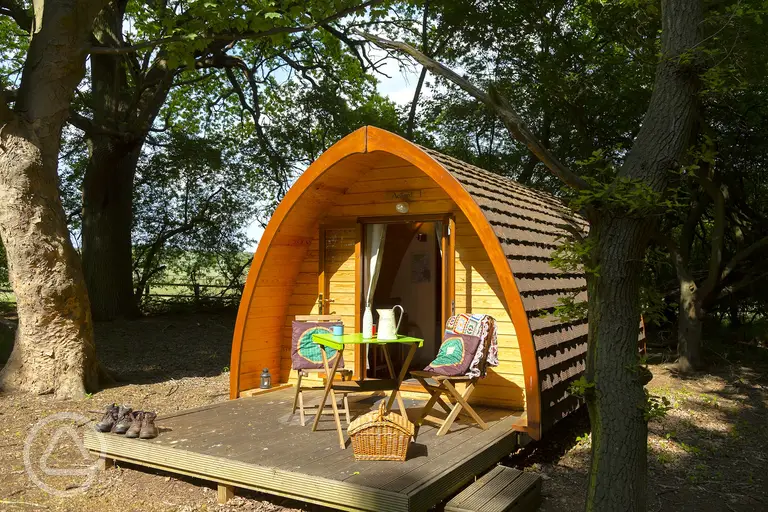 Glamping pod with a deck and outdoor furniture