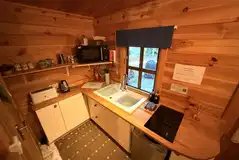 Woodland kitchen with a hob, fridge, microwave, toaster and kettle Woodland kitchen with a hob, fridge, microwave, toaster and kettle