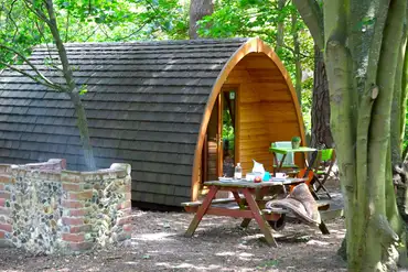 Glamping pod with an outdoor deck and brick BBQ