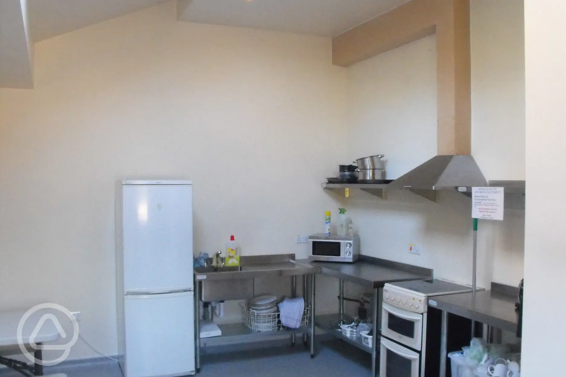 The kitchen has got 2 cookers, fridgefreezer, microwave, toaster, 2 kettles and a microwave. Crockery and cutlery and pots and pans. There are 3 large wooden tables with bench seating.