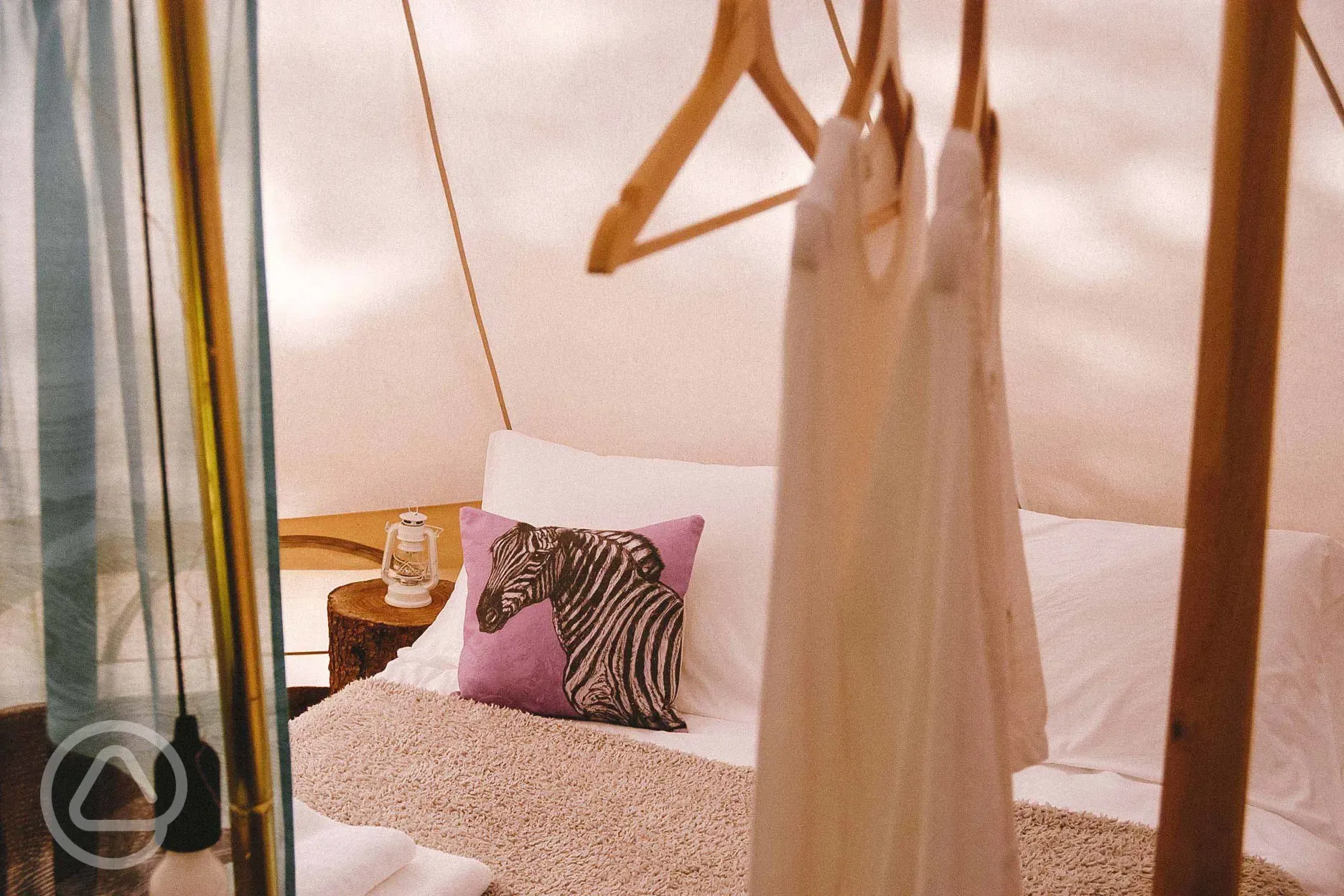 Bell Tent interior featuring bespoke furniture and fabrics