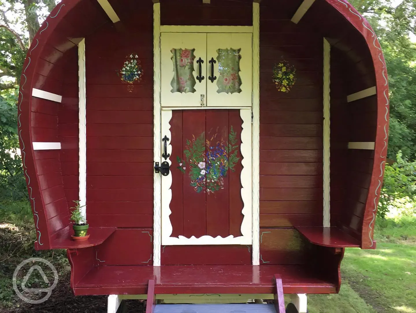 Gypsy caravan with beautiful art work of woodland flowers and chickens