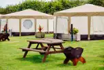 Yurts with picnic benches and fire pits