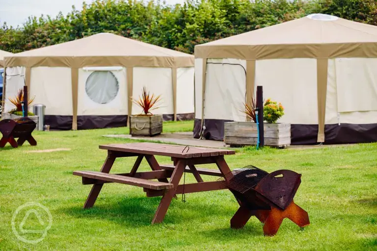 Yurts with picnic benches and fire pits