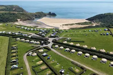 Aerial view of Three Cliffs Bay Holiday Park overlooking Three Cliffs Bay