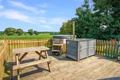 Owl pod with a picnic bench and hot tub