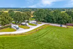 Aerial of the fully serviced hardstanding pitches lined with trees