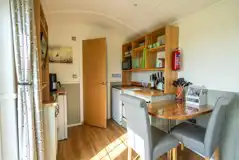 The hut seating area and kitchen with a fridge, air dryer, hot plate and more