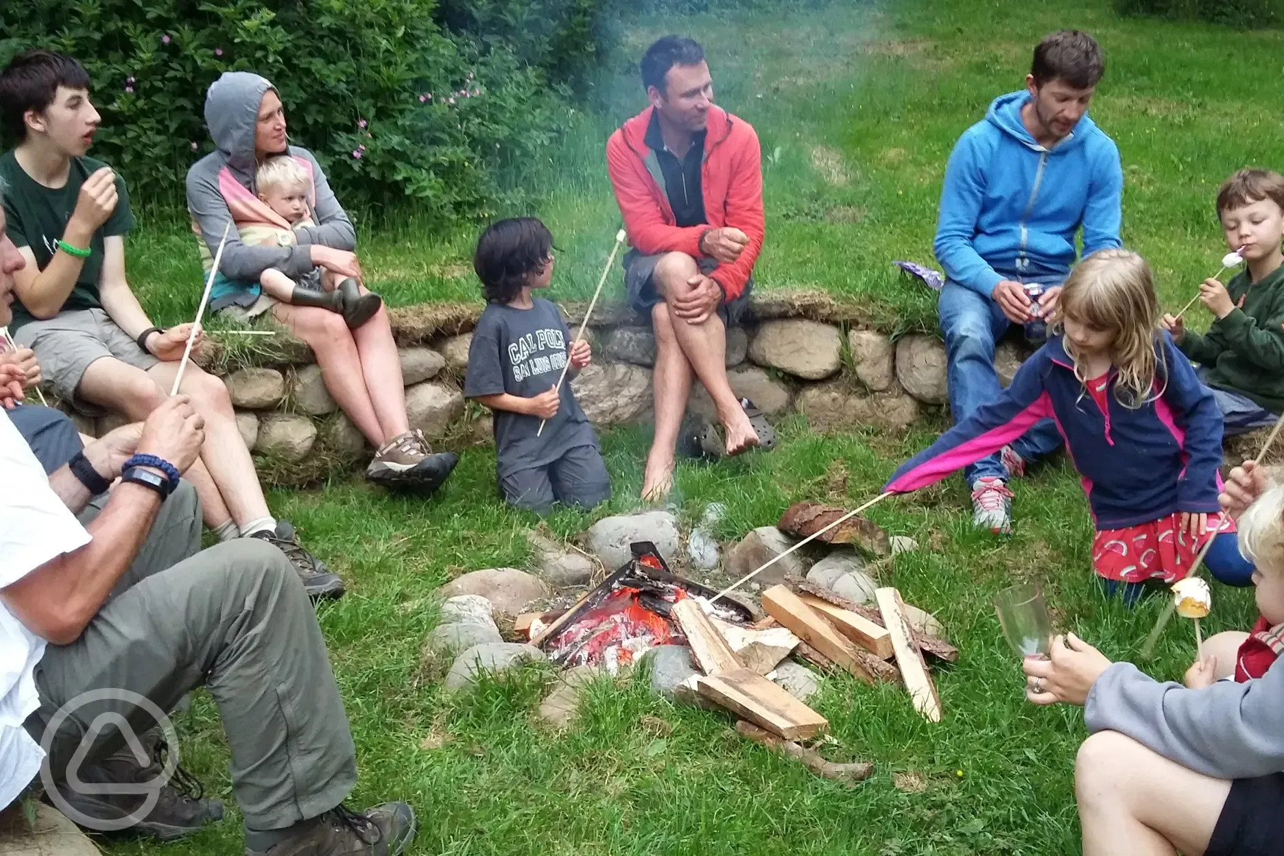 Communal camp fire and marshmallow toasting