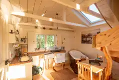 Wee Tree Howf Treehouse interior with a kitchen and slipper bath