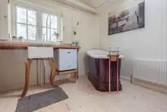 Wee Tree Howf Treehouse interior with a kitchen and slipper bath