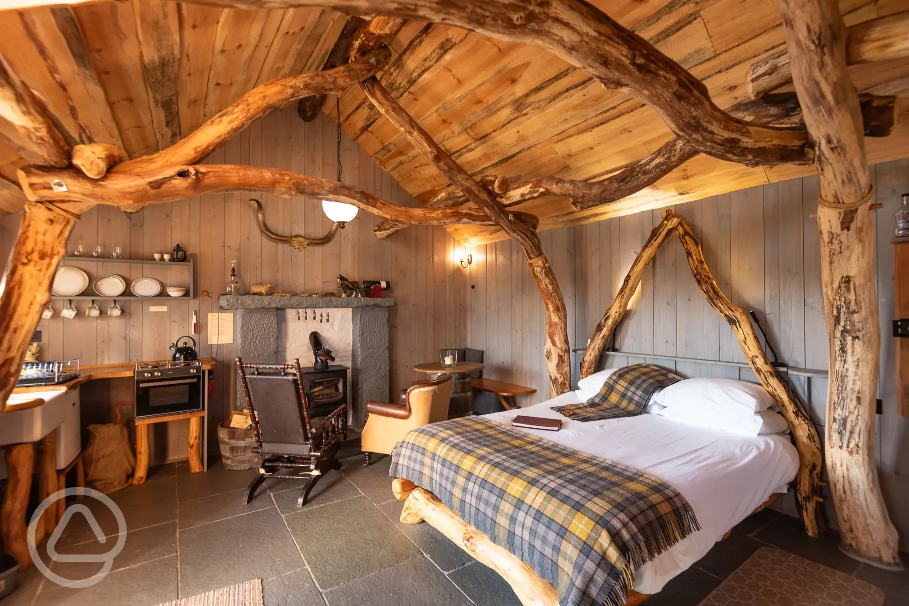 Whisky Howf Cabin interior with a wood burning stove