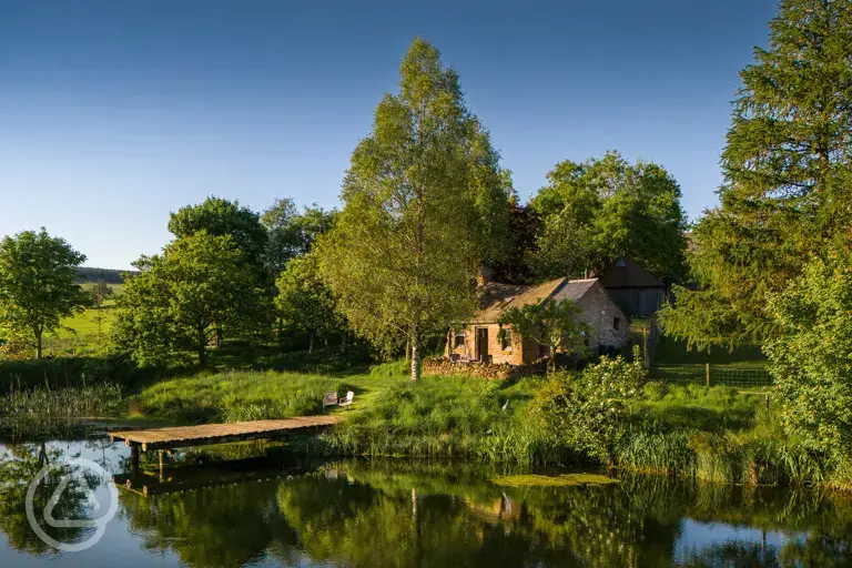 Whisky Howf Cabin with views of a lake