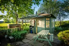 Summer Howf glamping cabin with a picnic table