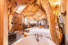 Whisky Howf Cabin interior with a king size bed and slipper bath