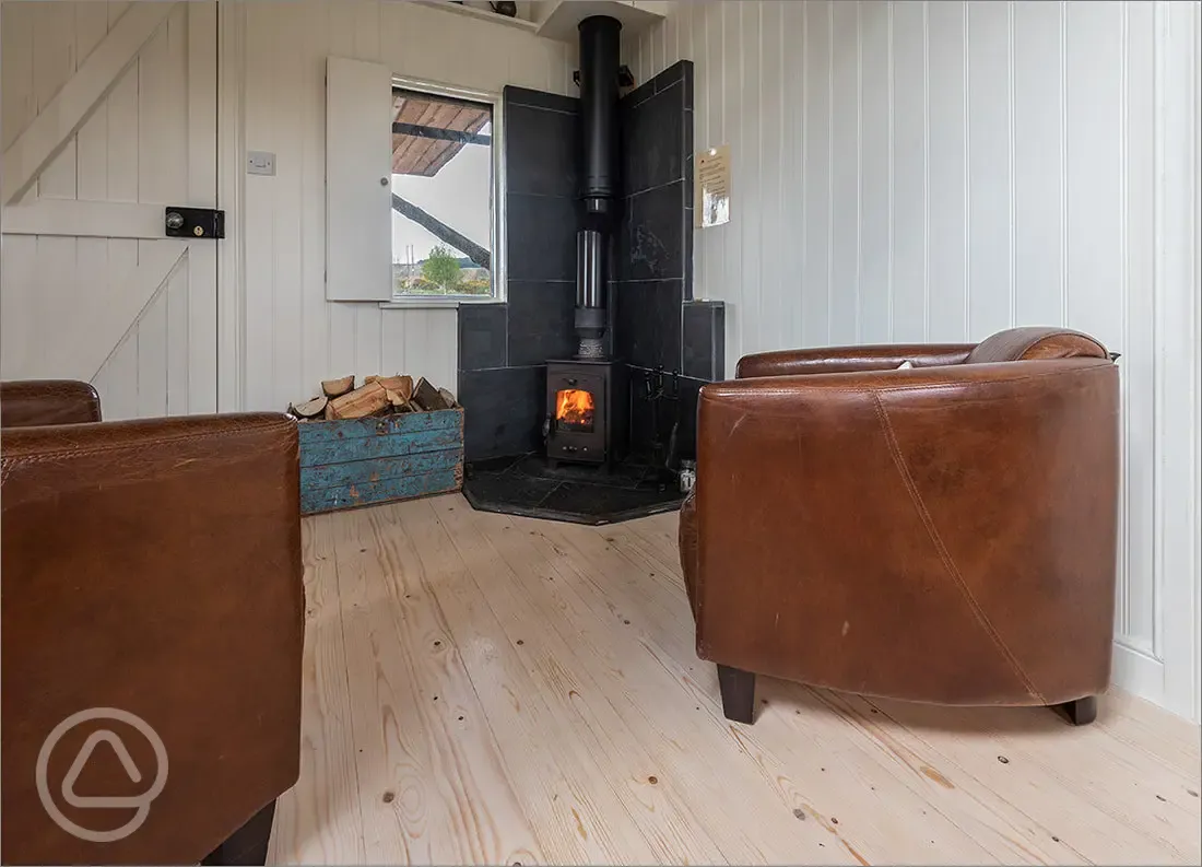Wee Tree Howf Treehouse interior with a wood burning stove