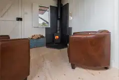 Wee Tree Howf Treehouse interior with a wood burning stove