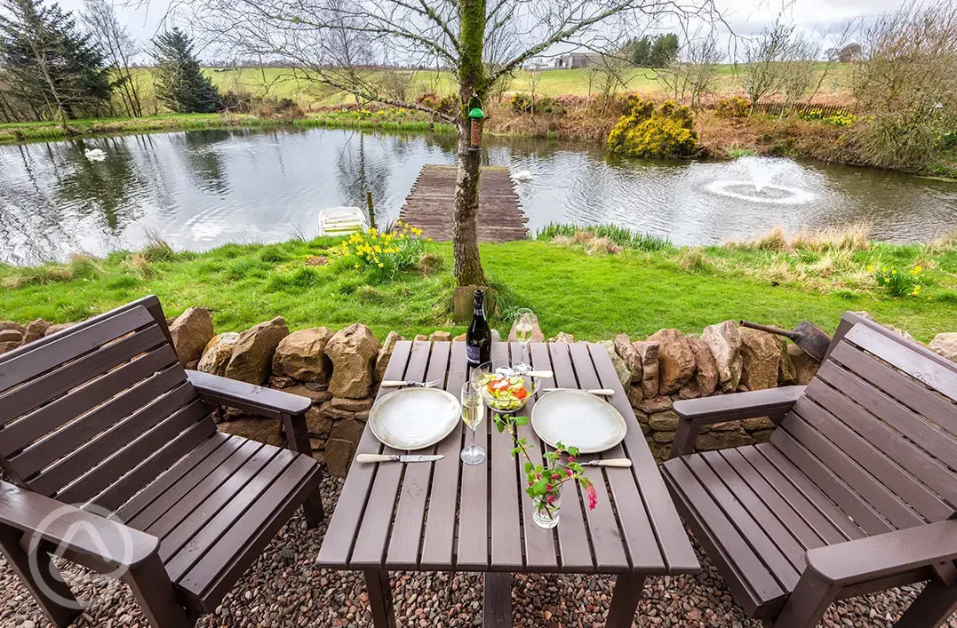 Whisky Howf Cabin outdoor seating area with lake views