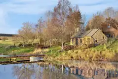 Whisky Howf Cabin with views of a lake
