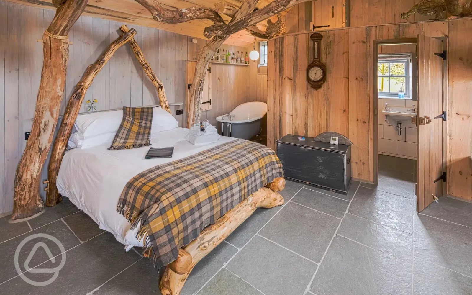 Whisky Howf Cabin interior with a king size bed and slipper bath