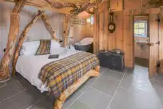 Whisky Howf Cabin interior with a king size bed and slipper bath