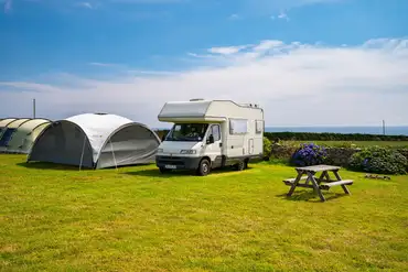 Non electric grass pitch with a picnic bench